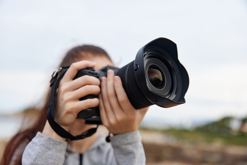 stock photo young woman capturing a beautiful landscape with a dslr camera expressing joy and passion for 2610189191